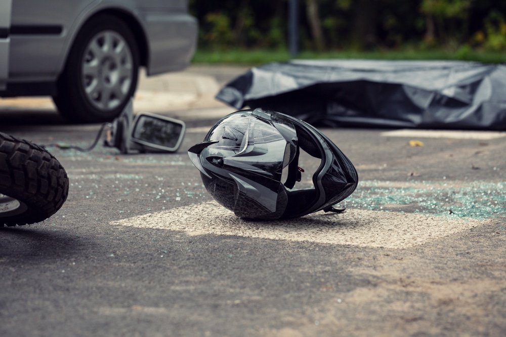 Black,Motorcycle,Helmet,On,The,Street,After,Collision,With,A